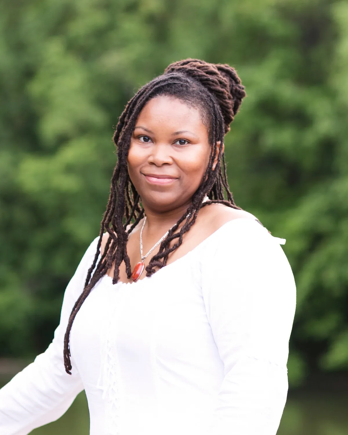 Nicole Jenkins, licensed psychotherapist, photographed outdoors beside water