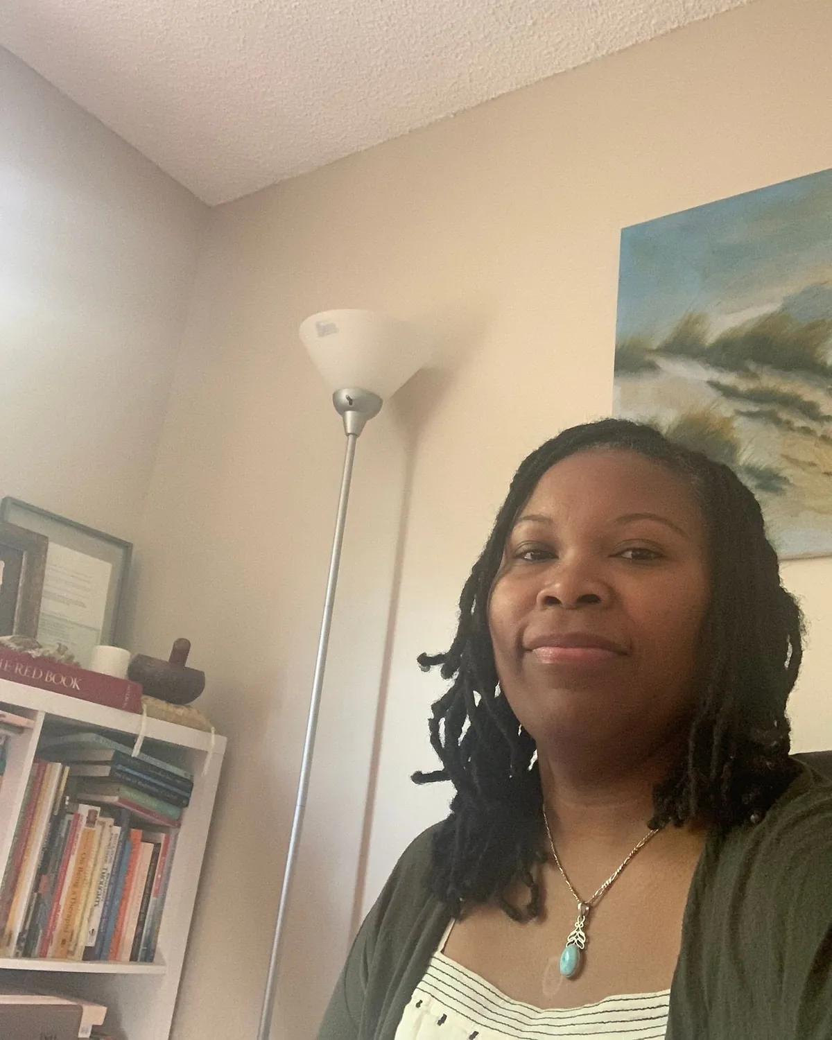 Nicole Jenkins smiling in her Brooklyn office beside a bookshelf